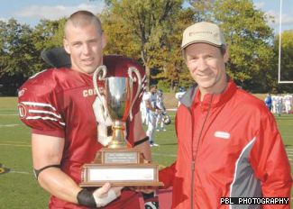 Linebacker Cory Greenwood accepts the Homecoming Cup from Gerry Prud’homme, an outstanding football player for Concordia in the 1980s. Prud’homme still holds a Canadian university record for the longest pass reception, a 109-yard strike on Sept. 20, 1980.